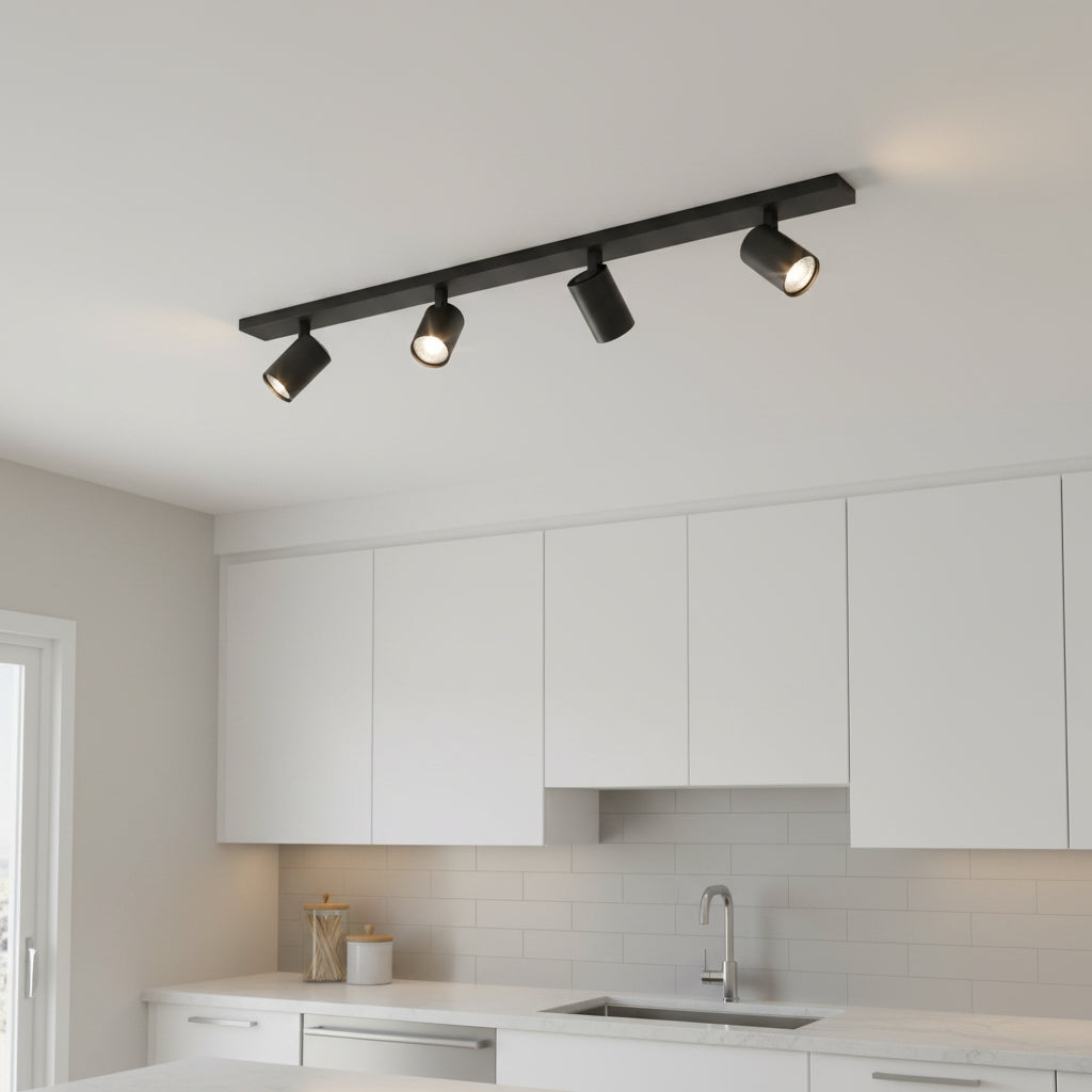 Black track lighting with four spotlights installed on a white kitchen ceiling