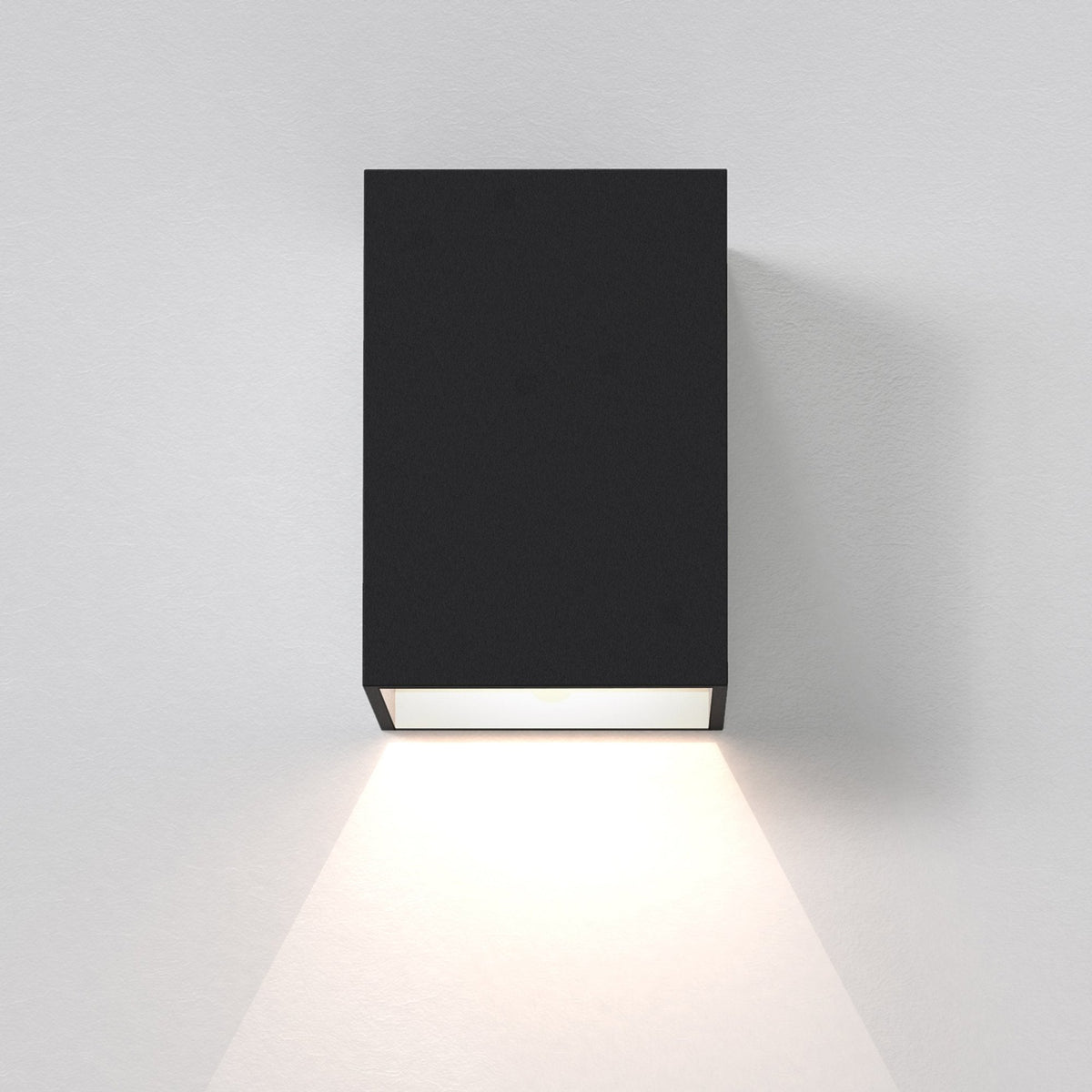 Black rectangular wall light with a downward-facing beam of light