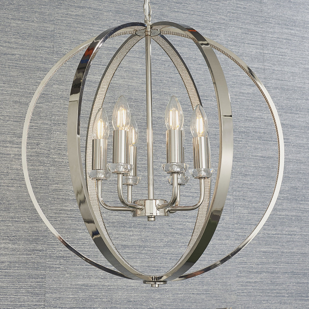Polished nickel chandelier with five candle-style bulbs inside a spherical frame.