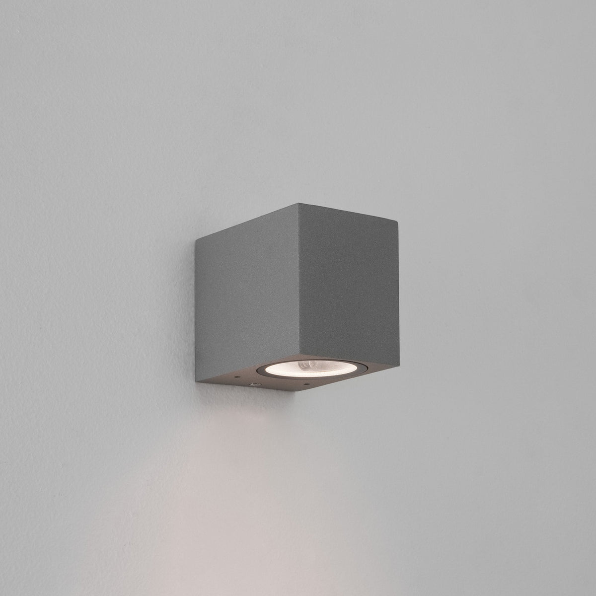 Grey square wall light with a single bulb pointing downwards