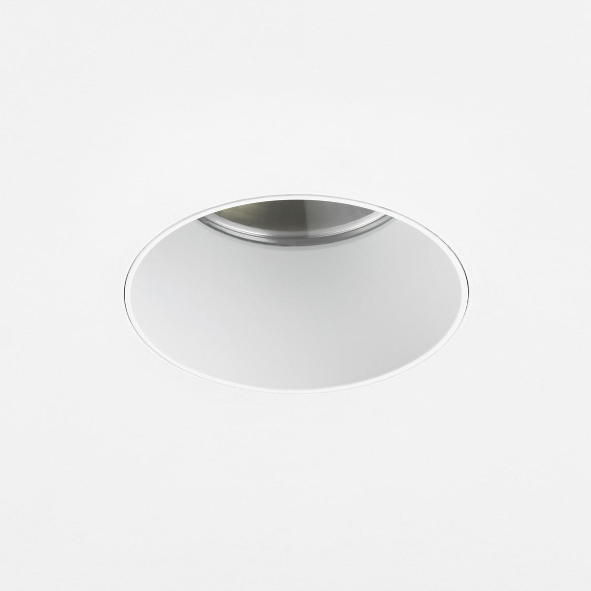 Round recessed light fixture with a white trim and a silver interior