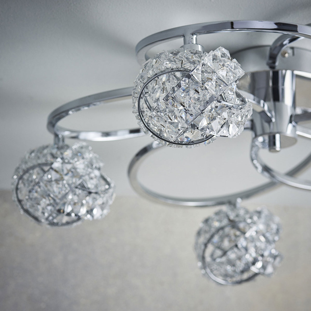 Close-up of a chrome ceiling light with crystal sphere shades.
