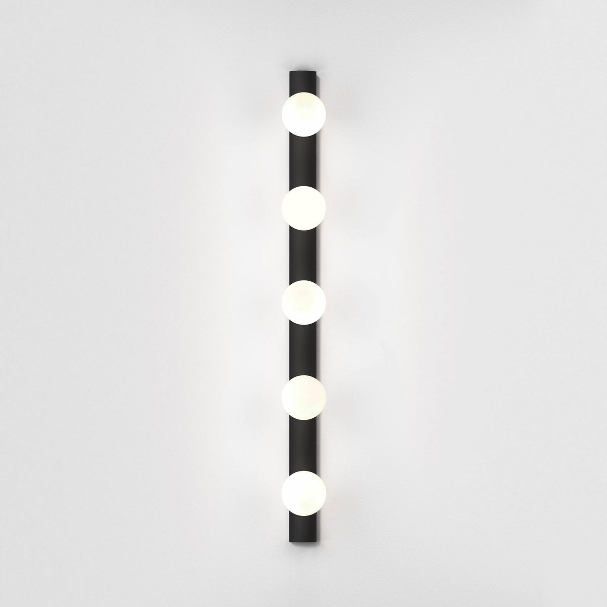 Black vertical light fixture with five round white bulbs