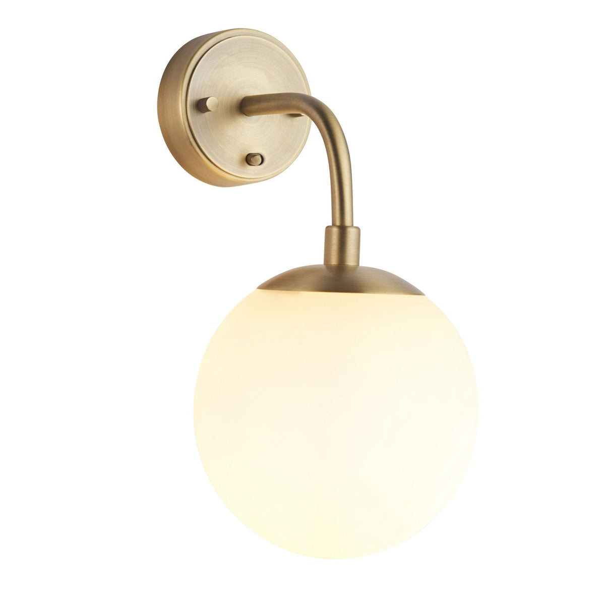 A brass wall light with a white globe shade, isolated on a white background, illuminated.