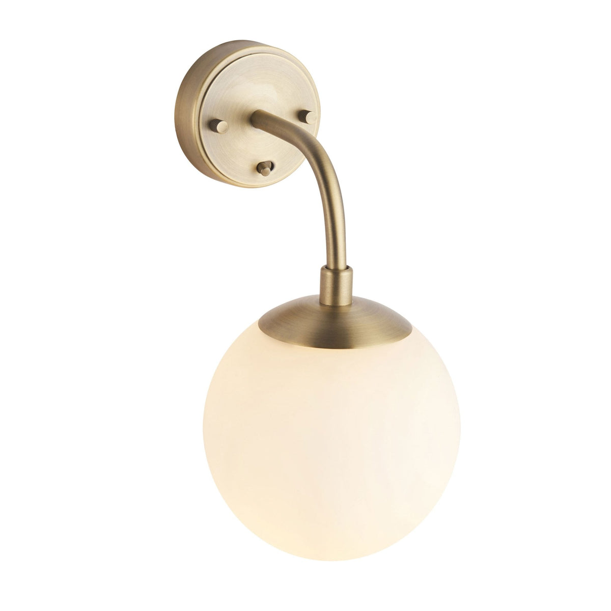 A brass wall light with a white globe shade, isolated on a white background, illuminated.