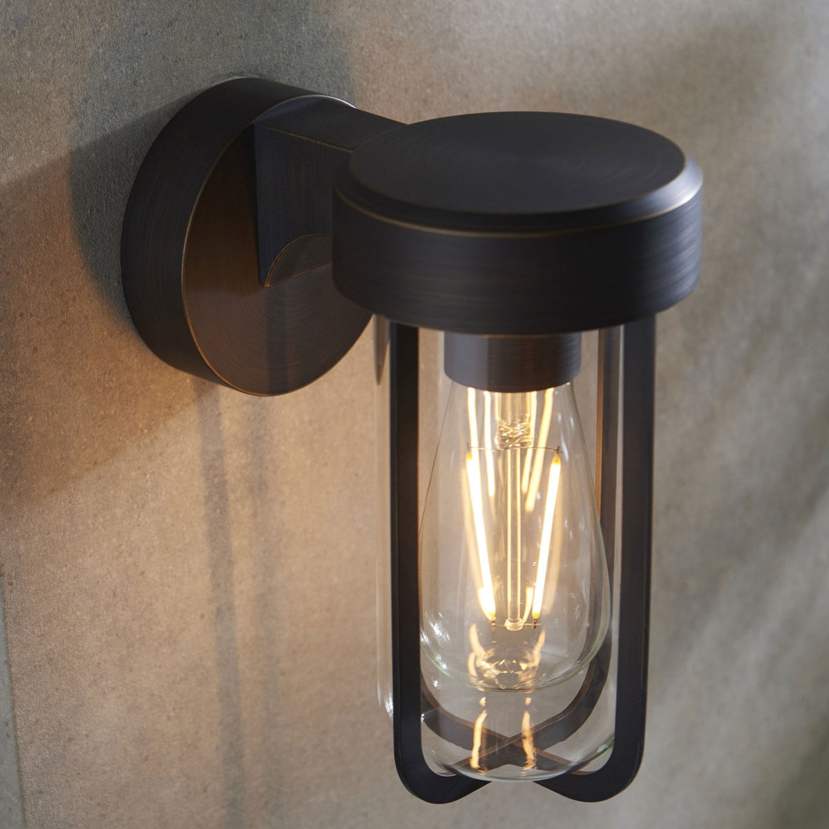 Applique murale extérieure ou de salle de bain en métal noir avec ampoule à filament exposée.