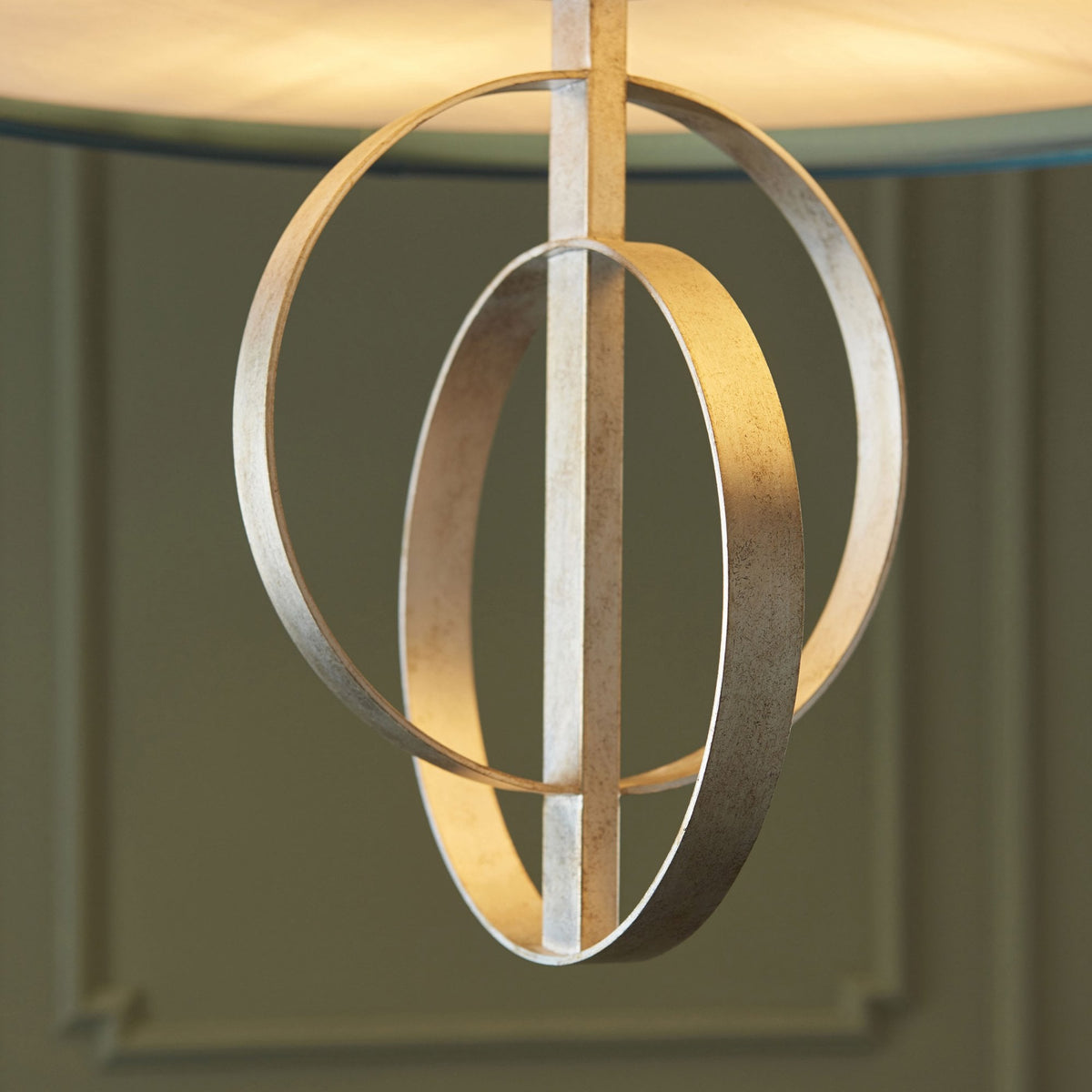 A close-up of the intricate silver orbit design, showcasing its elegant curves and metallic finish.