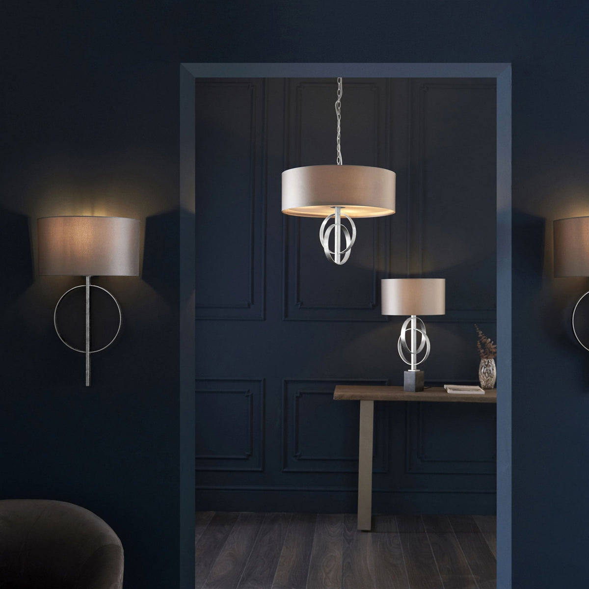 A room with matching wall lights, a table lamp, and a pendant light, all in beige and champagne gold.