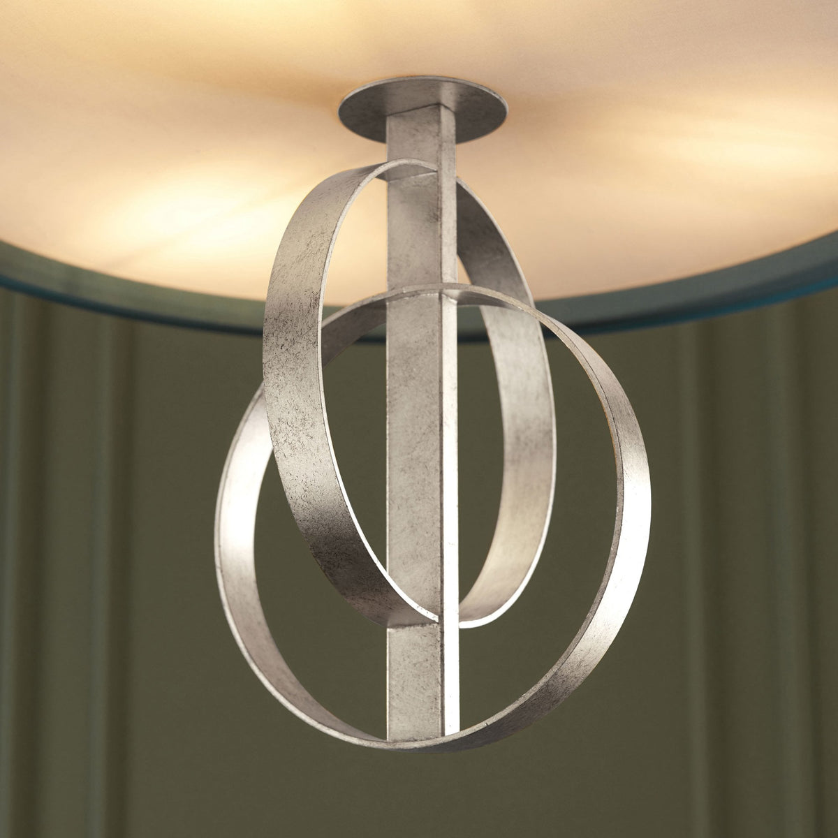A close-up of the pendant light's brushed silver circles, emphasizing the modern design.