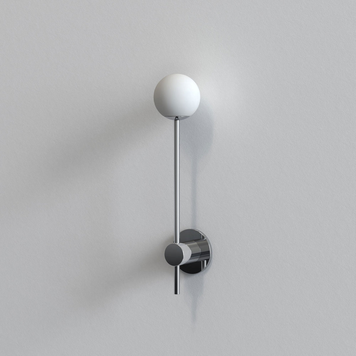 Chrome wall-mounted light fixture with a white spherical shade