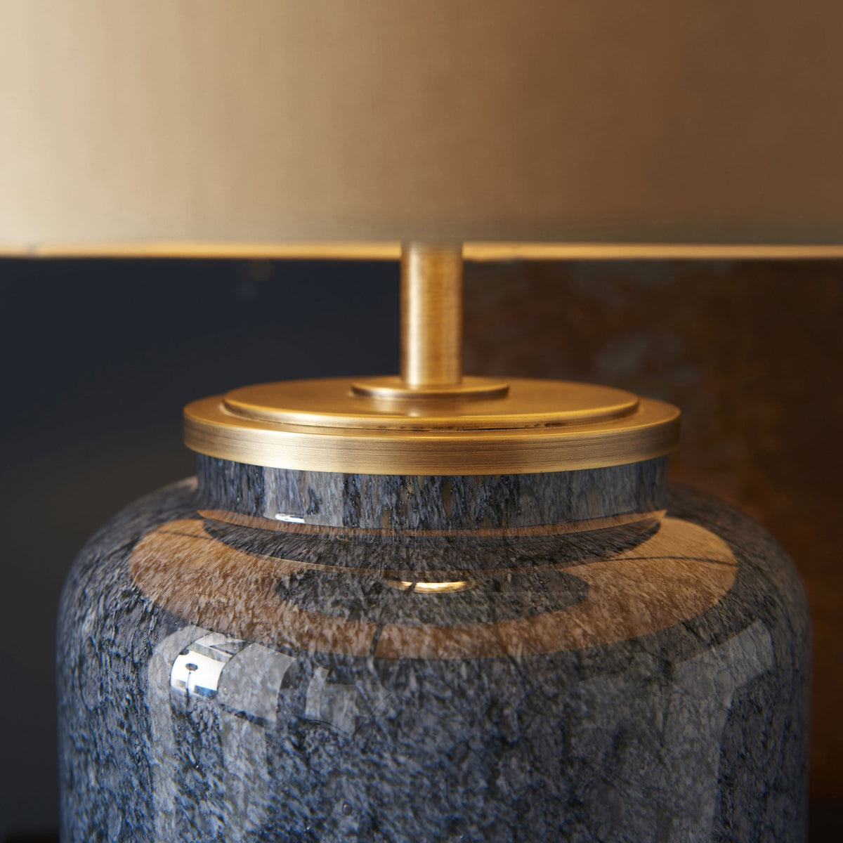 A close-up of the blue glazed lamp base and brass details.