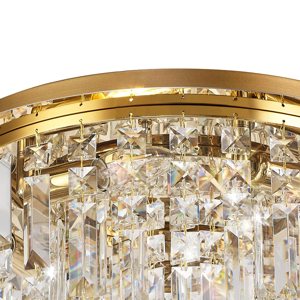 Close-up of the brass base and upper crystal accents of the light fixture.
