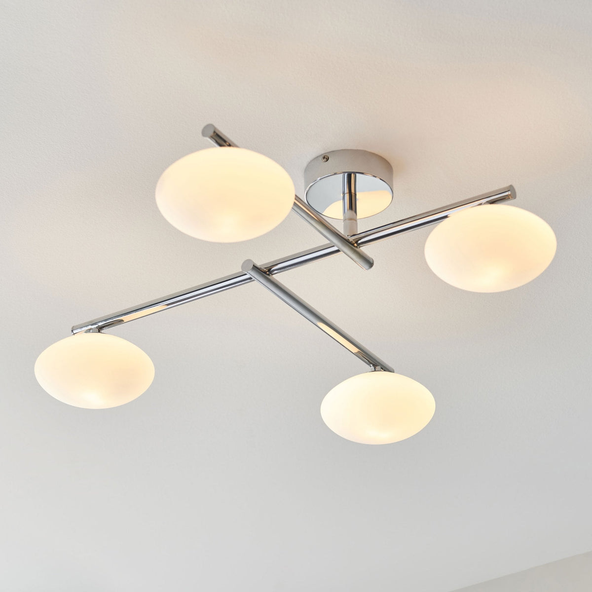 Four-light ceiling fitting with chrome finish and opal glass shades.