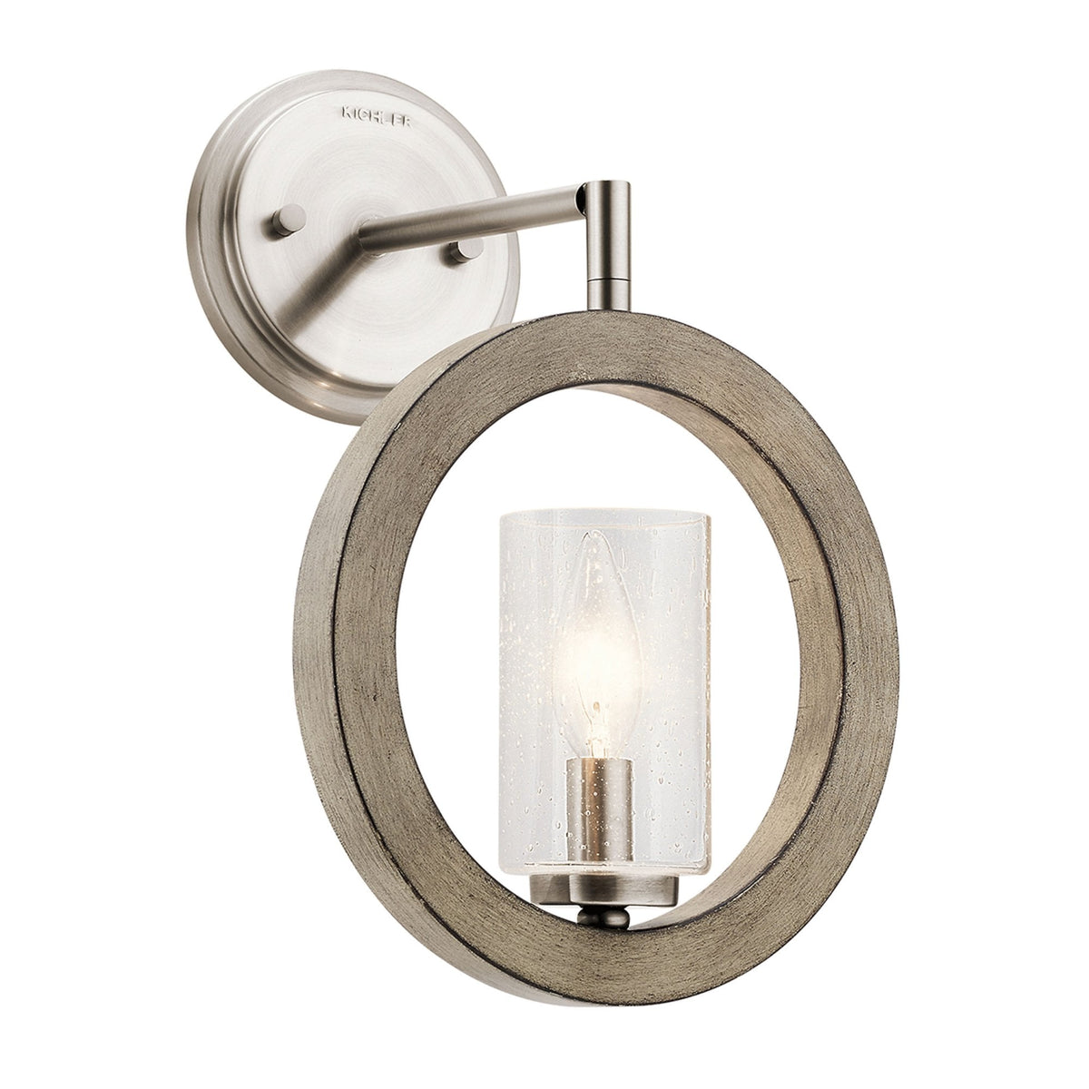 A modern wall sconce featuring a weathered wood ring and a cylindrical glass shade.