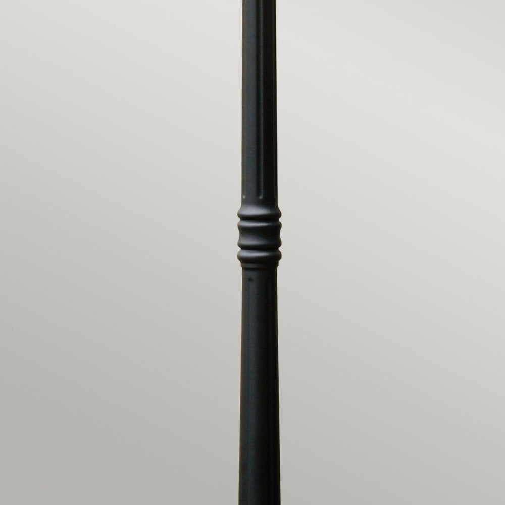 Detail of the elegant fluted column on a black street lamp, adding a touch of sophistication.