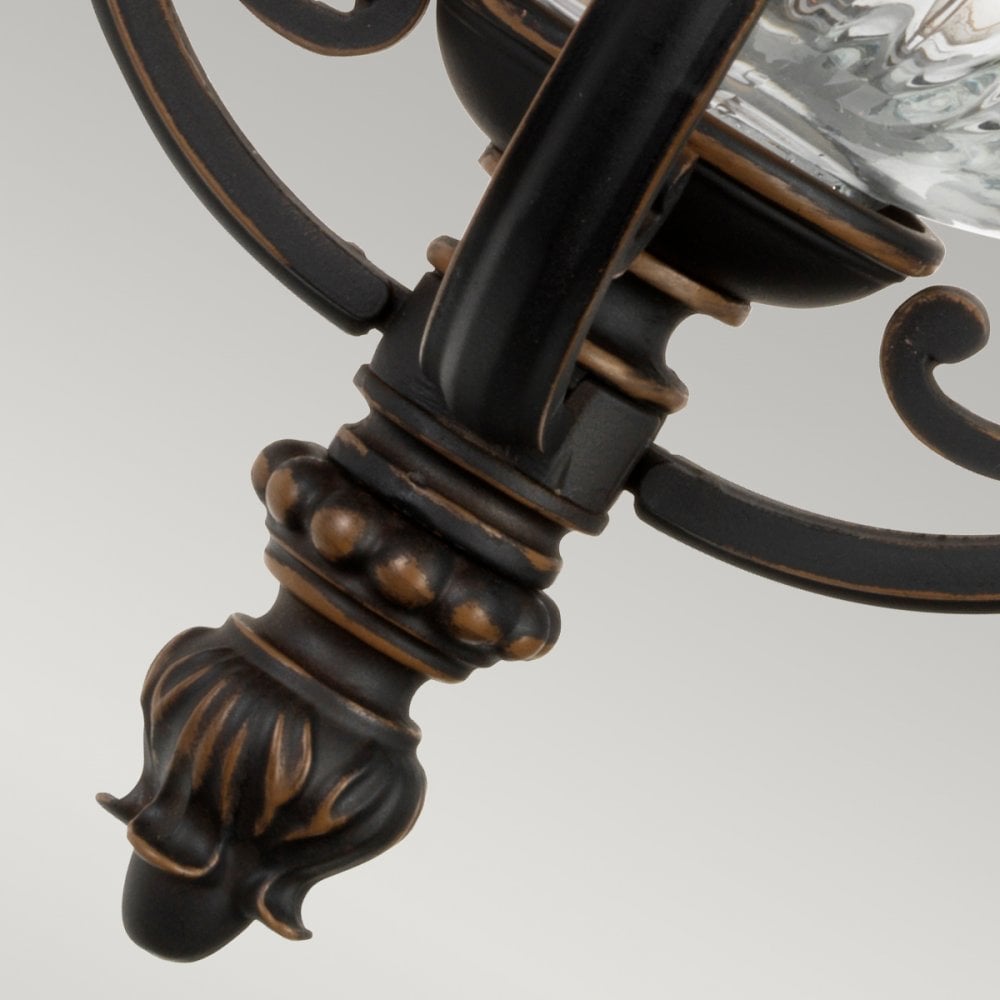 Detailed view of the decorative base finial on the outdoor wall light.