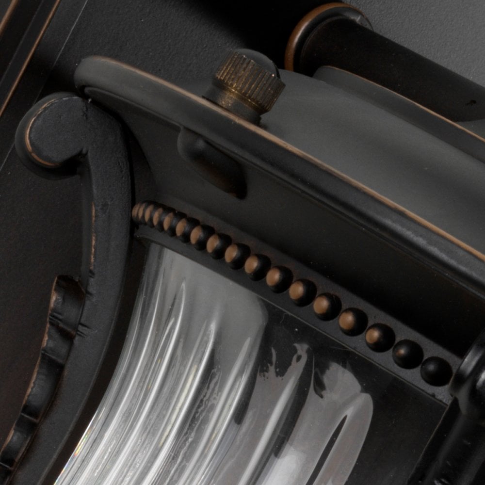 Detailed view of the textured black metalwork and glass on the outdoor wall light.