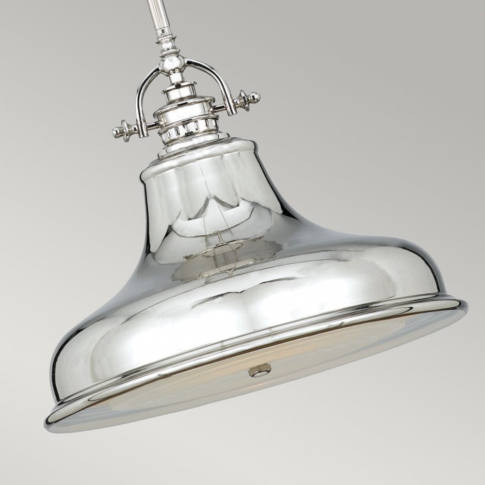 Close-up of a single polished nickel pendant light with a fluted bell shade.