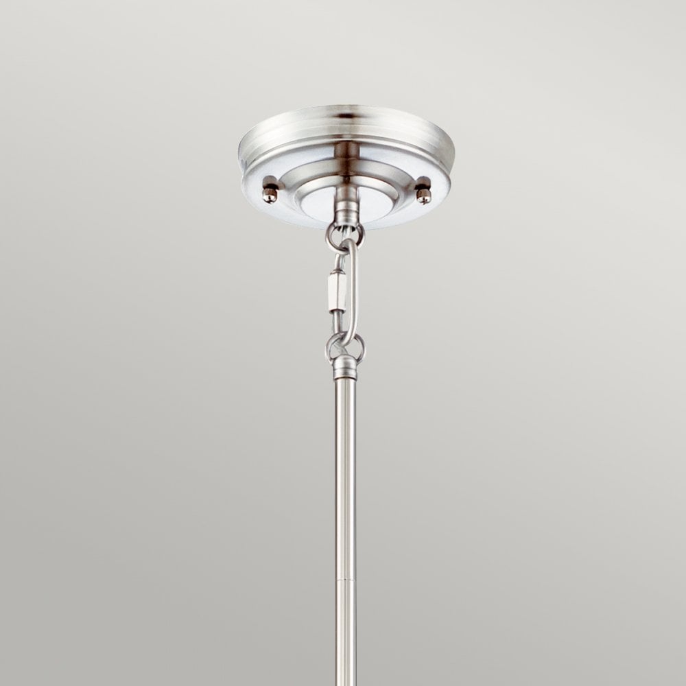 Ceiling mount of a polished nickel pendant light showing the rod and canopy detail.
