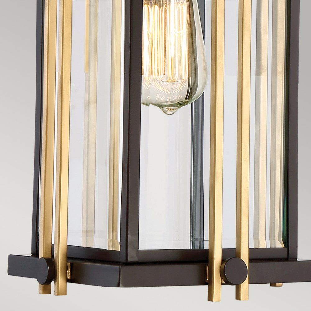 Bottom detail of the outdoor pendant light, showcasing the bronze and brass framework.