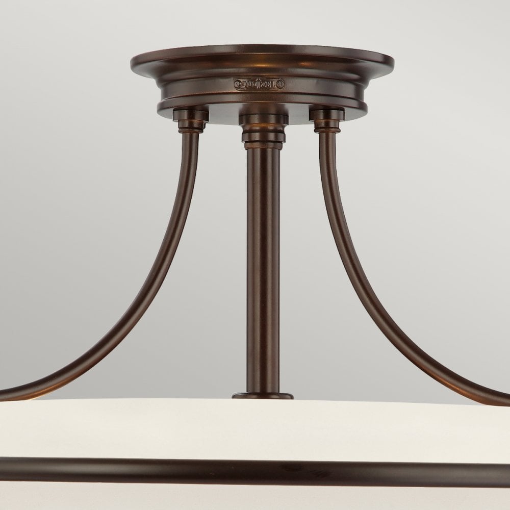 A close-up view of the ceiling mount and arms of the semi-flush ceiling light.