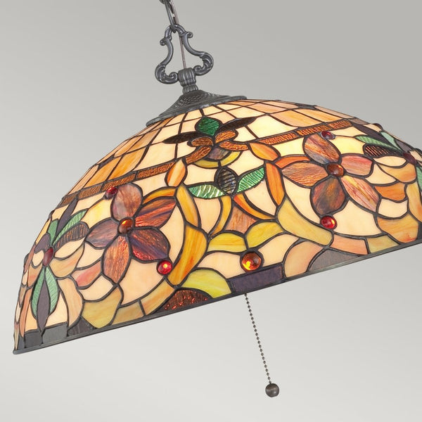 Close-up of the dome-shaped stained-glass ceiling light, highlighting the floral pattern.