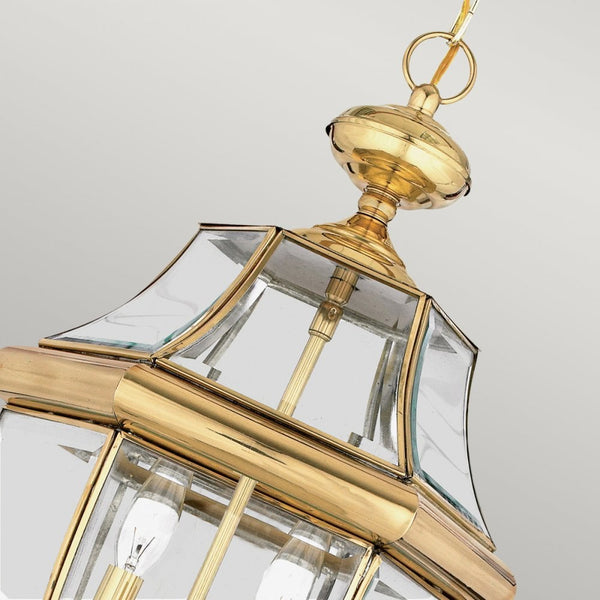 Close-up of the upper section of a brass and glass hanging lantern.