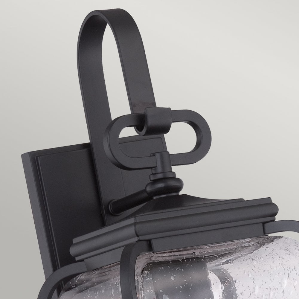 Close-up of the decorative black mounting bracket and top of the outdoor wall light.