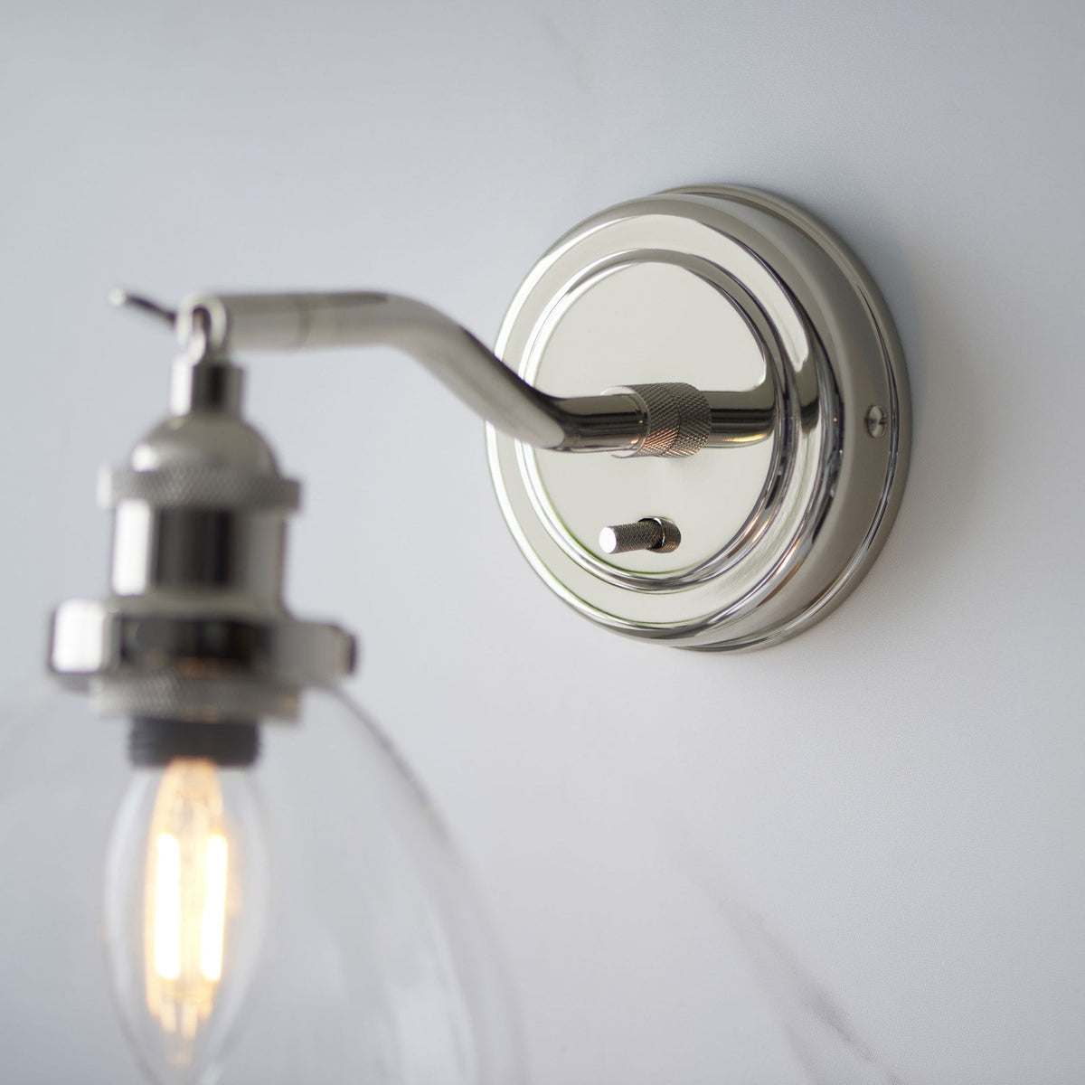 Hansen Switched Wall Light in a Bright Nickel Finish with Clear Glass