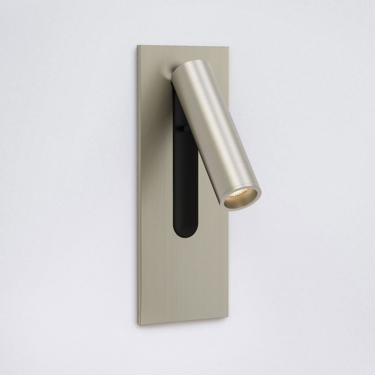Brushed nickel wall-mounted light fixture with a cylindrical, adjustable spotlight