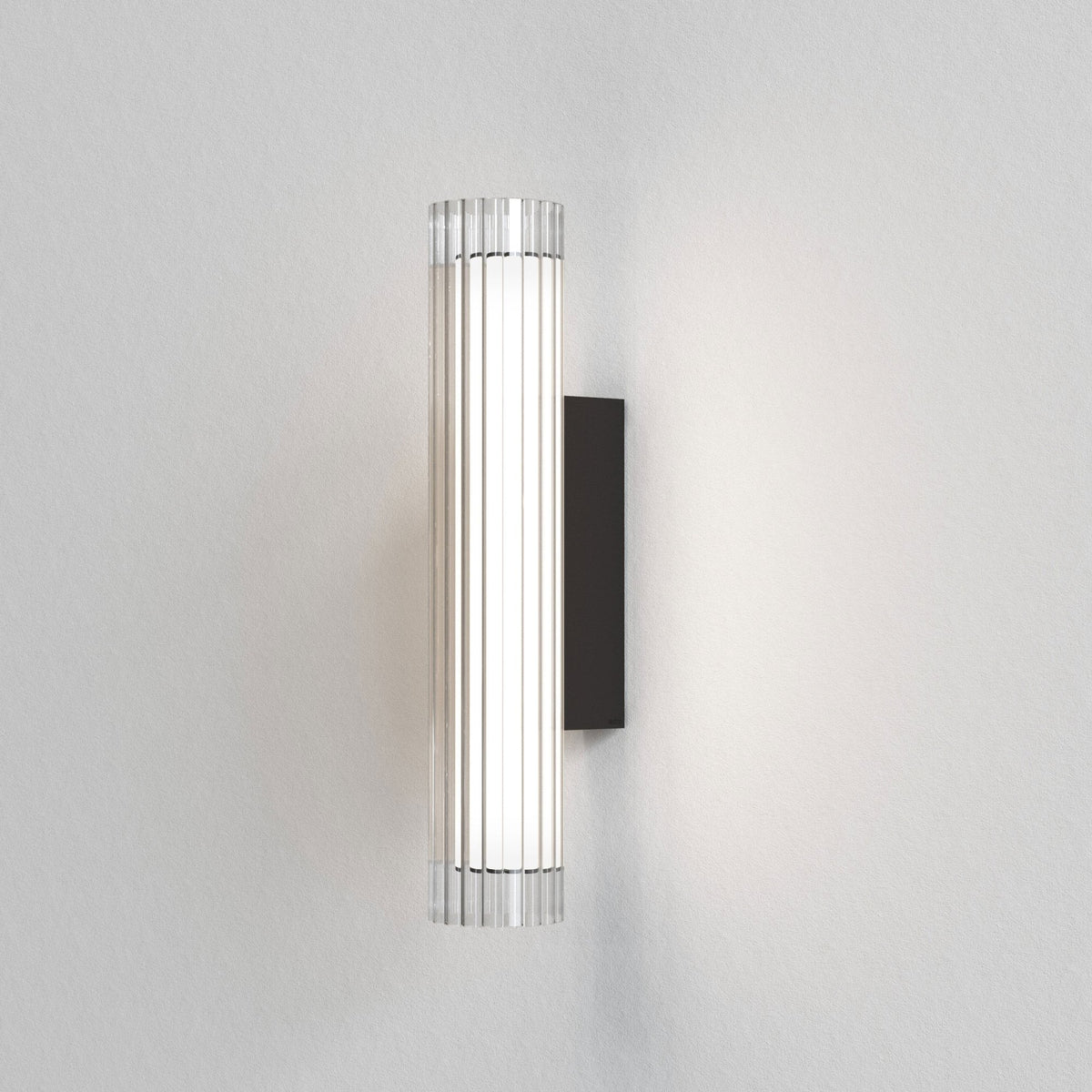 Cylindrical wall light with fluted glass diffuser and black backplate