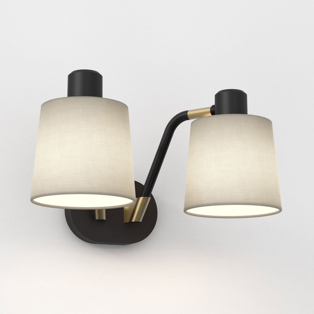 Two light wall sconce with black and brass accents and light fabric shades