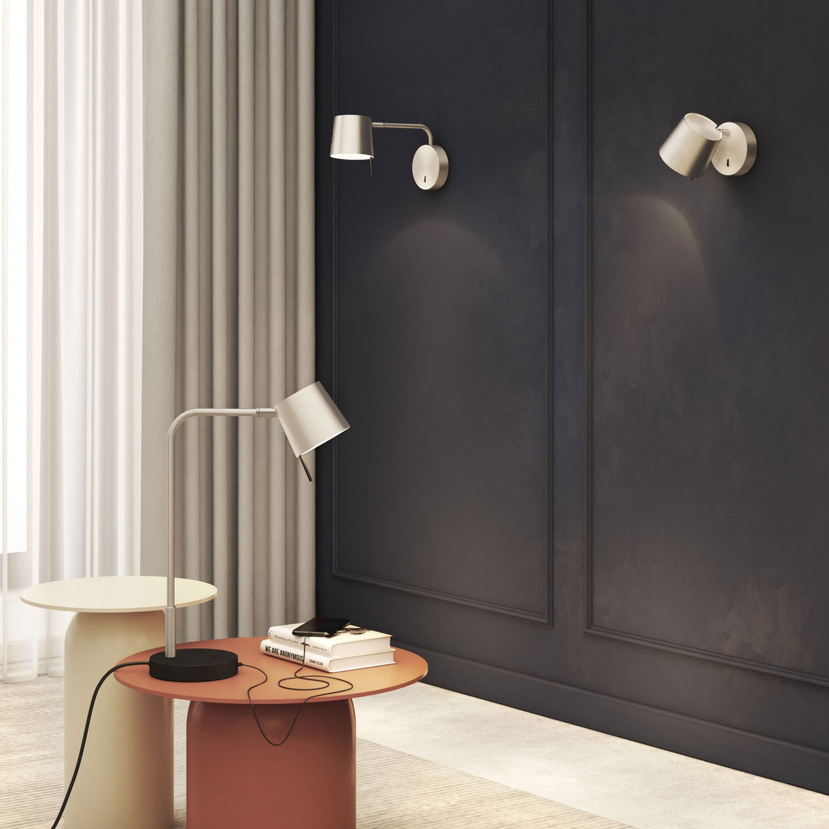Two wall-mounted lamps and one desk lamp illuminate a dark wall and two round tables