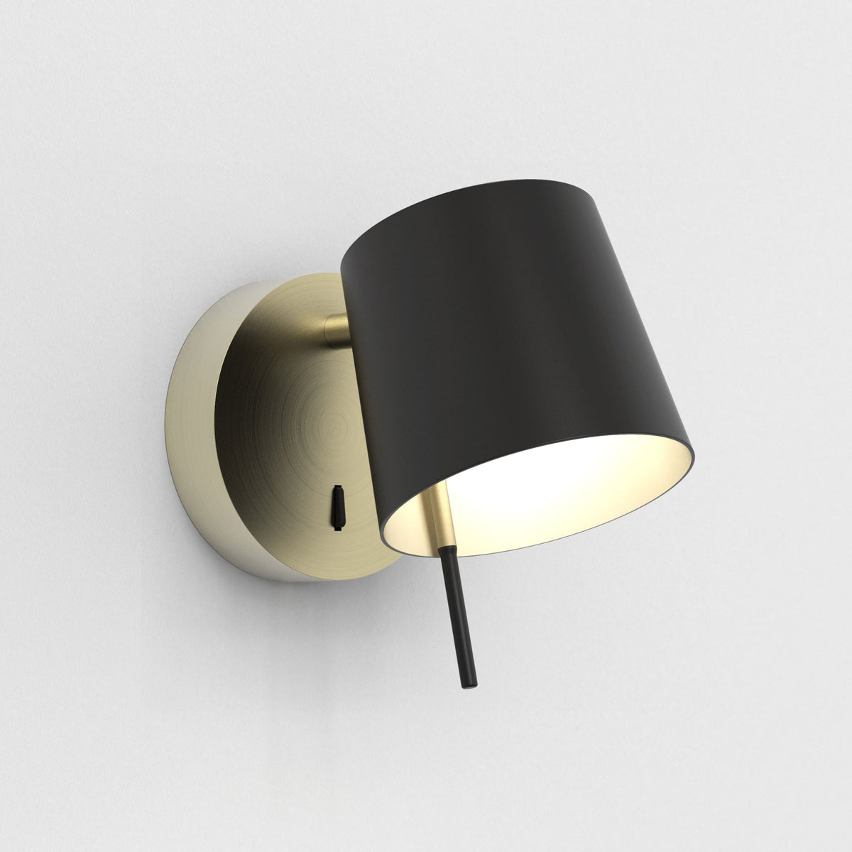 Black and gold wall lamp with a conical shade and a small toggle switch on the base