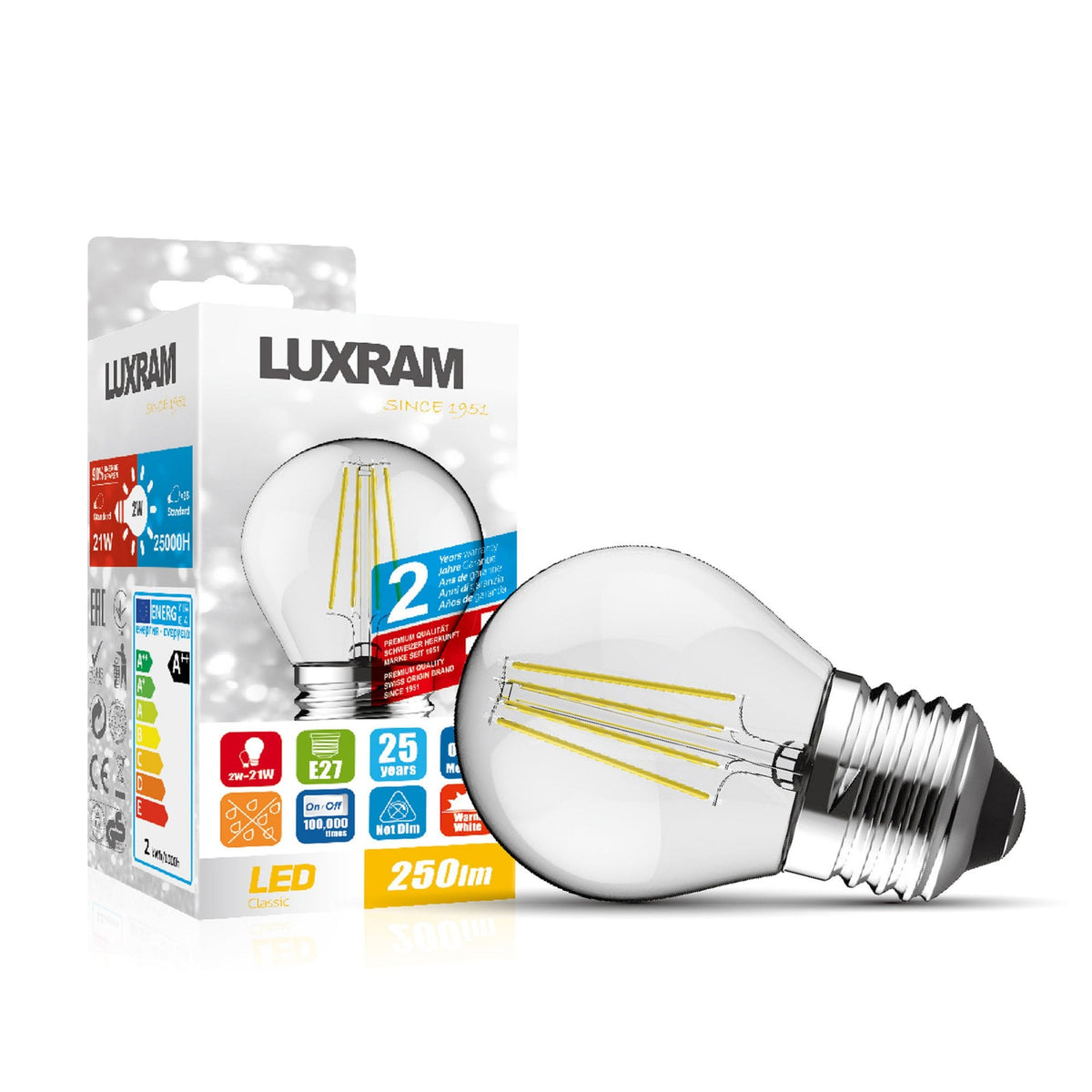 A clear LED filament bulb with a chrome screw cap next to its white and grey packaging.