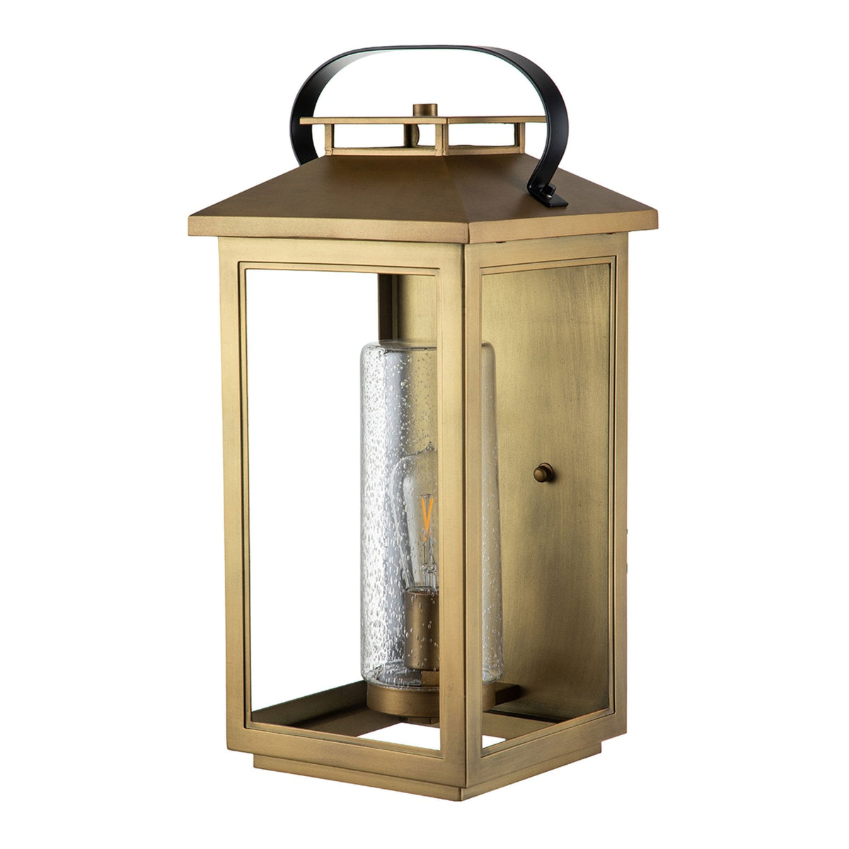A brass outdoor wall lantern with a clear seeded glass cylinder and a single exposed bulb.