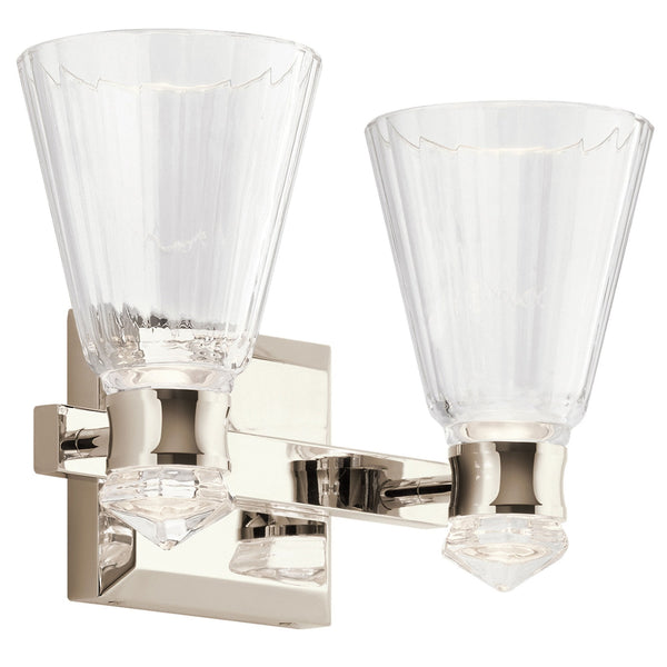 A close up of a two light nickel and crystal wall sconce.