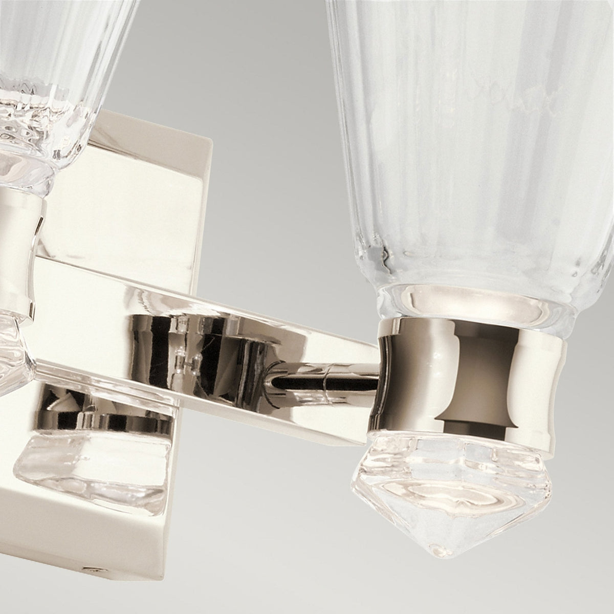A close up of the clear crystal detail on a two light nickel and crystal wall sconce.