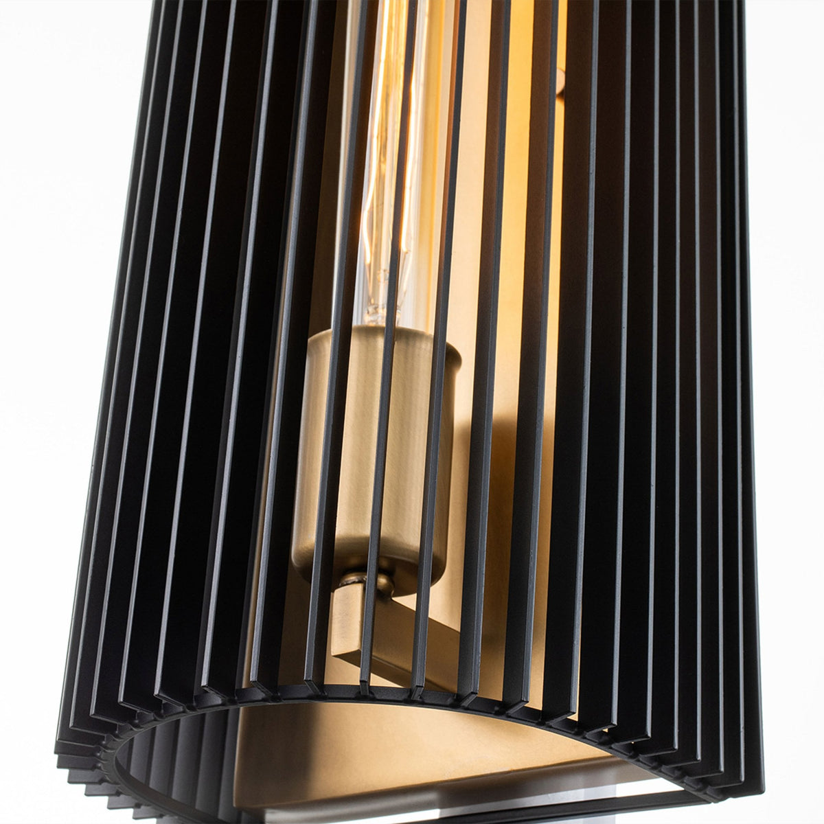 A detailed view highlights the vintage-style filament bulb within the contemporary sconce.