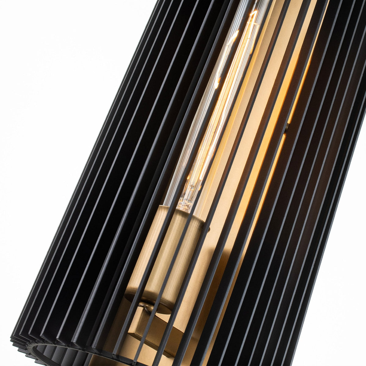 An angled shot shows the textured light play from the black slatted design and Edison bulb.