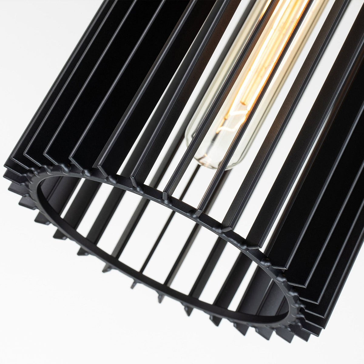 Close-up of the fluted black shade of the pendant light, showcasing its intricate design.