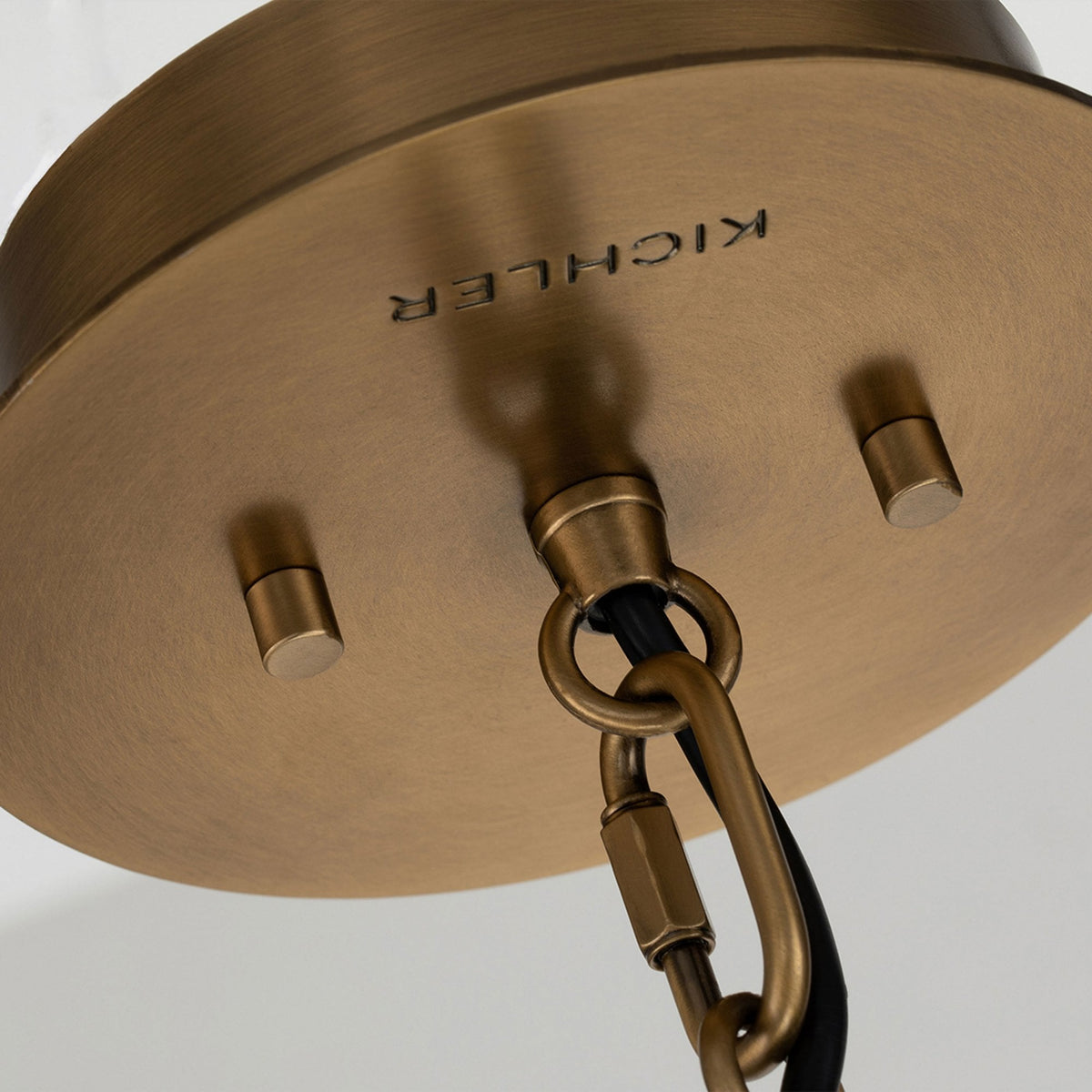 Detailed view of the brass ceiling rose with 'KICHLER' embossed, indicating quality.