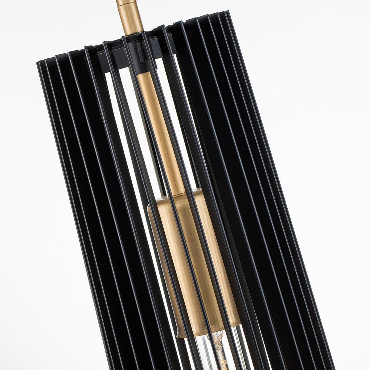 Angled shot revealing the brass bulb holder inside the fluted black pendant shade.