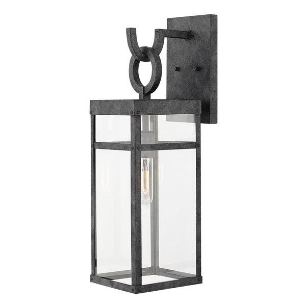 An industrial wall light featuring a rectangular glass shade and a dark metal frame.