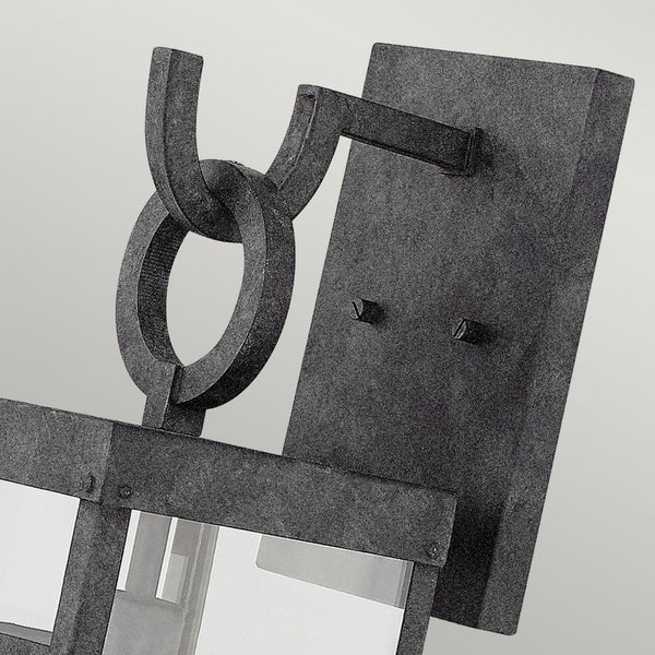 Close-up of the wall-mounted fixture of the industrial light, showing a metal ring accent.