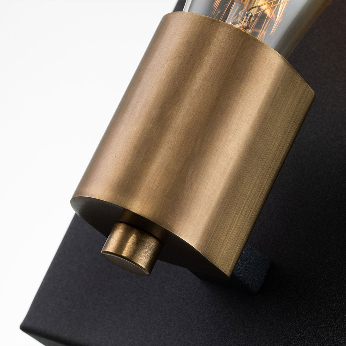 Close-up of the brass bulb holder and bottom detail of the wall light.