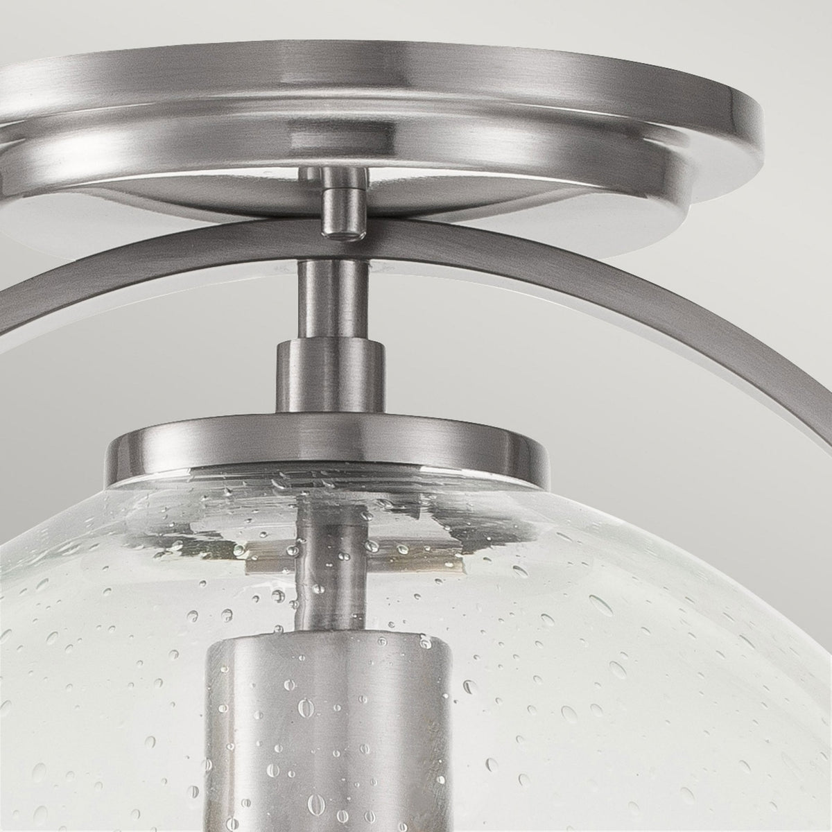 A close-up of the light fixture's connection point, highlighting the brushed nickel finish.