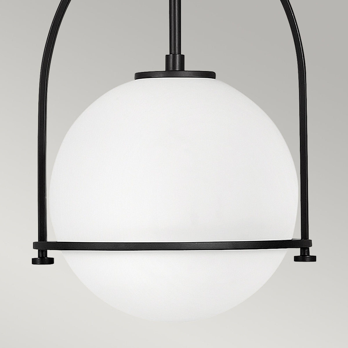 A close-up of the white spherical shade, encircled by a black metal band and frame.