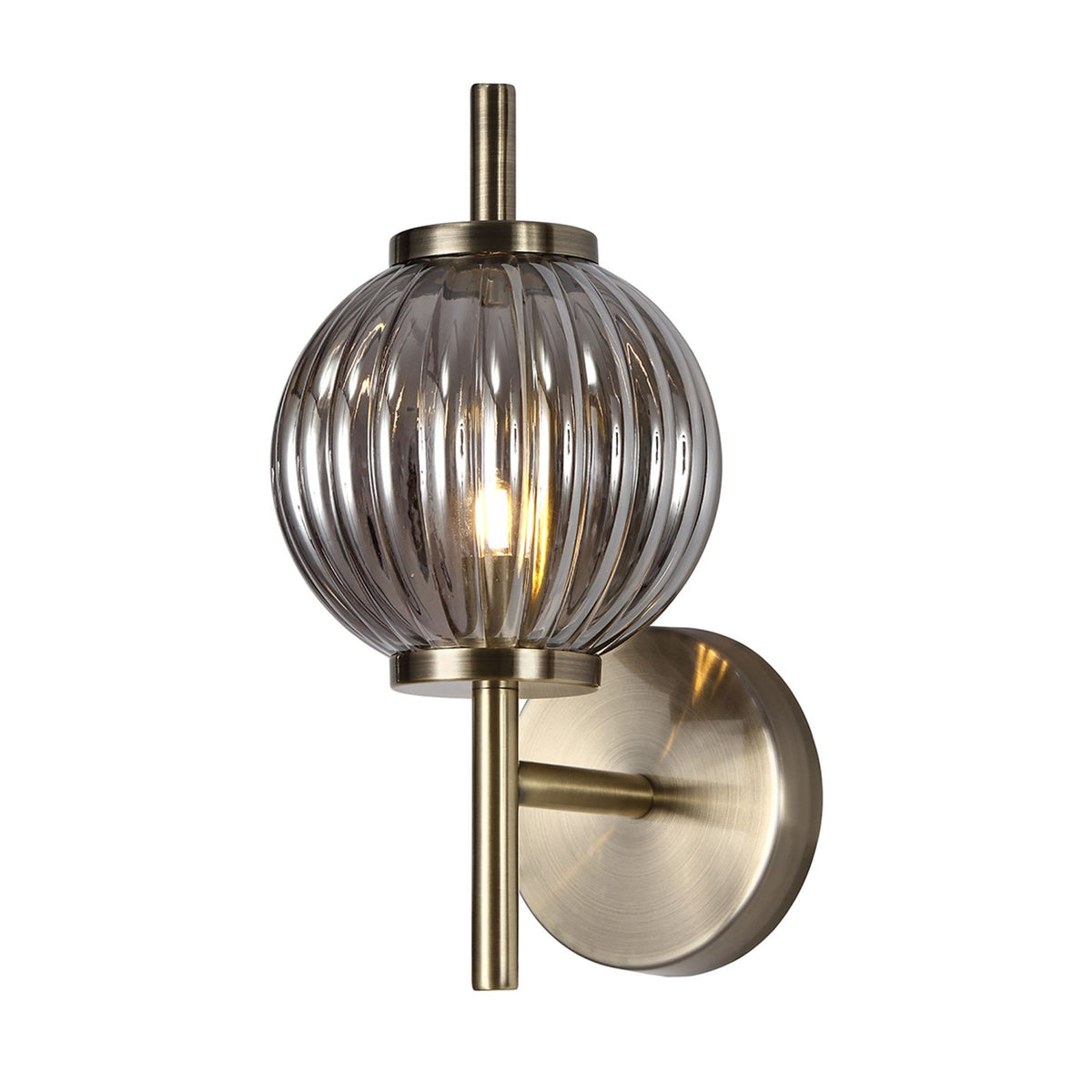 Ribbed smoked glass wall light with antique brass fittings viewed from an alternate angle.