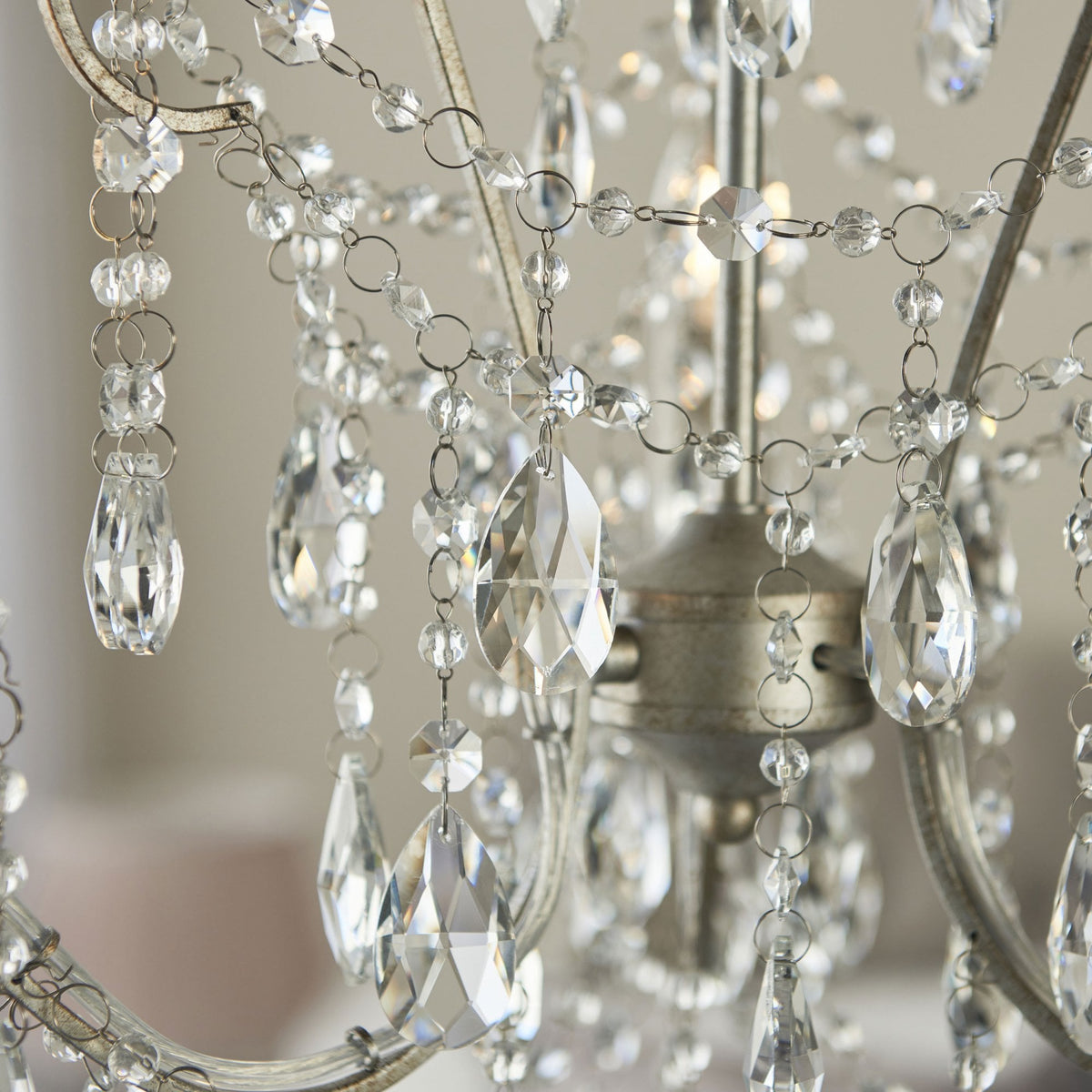 Close-up of the crystal beads and teardrop pendants on a chandelier.